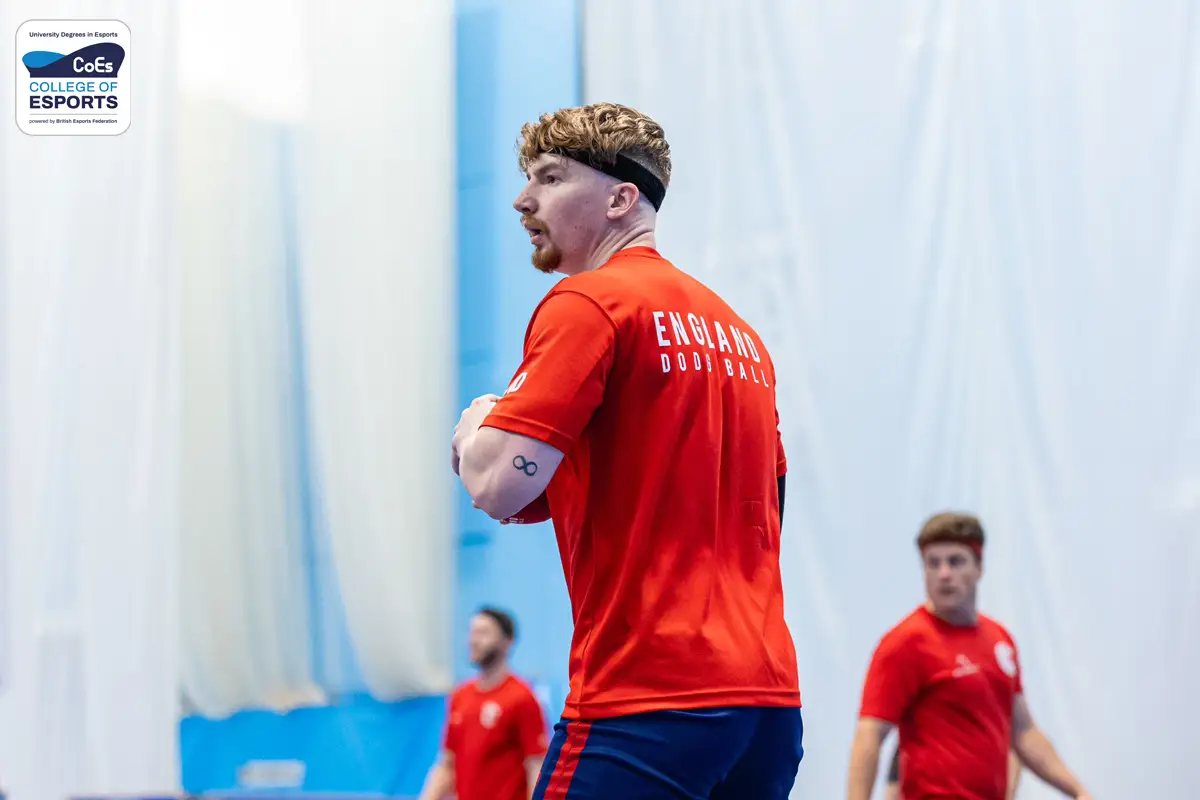 Image depicts Nathan David, Head of Foundation at University Campus of Esports, playing dodgeball in the red England Lions kit.