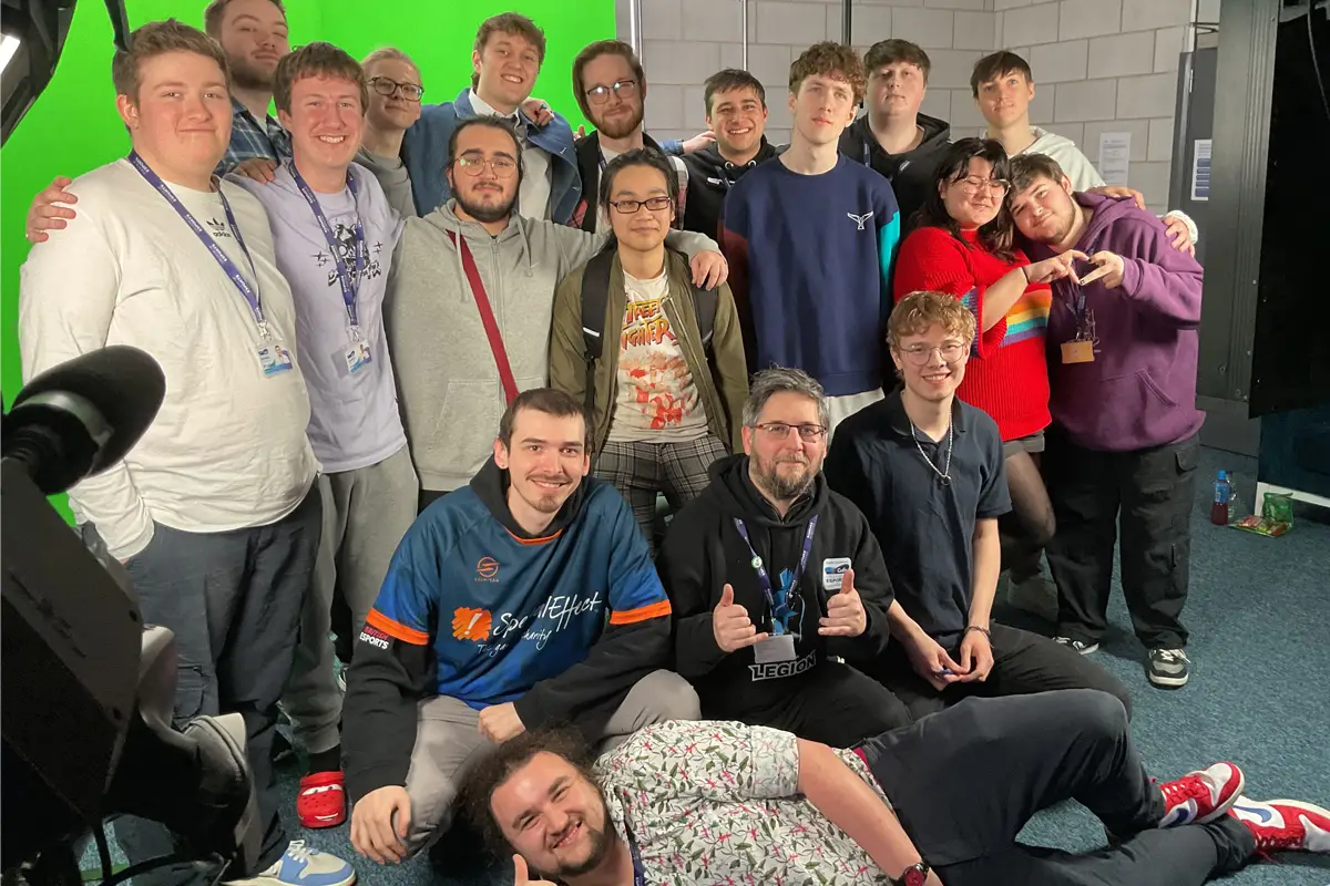 Image depicts the student and staff team in front of the green screen after finishing the SpecialEffect Gameblast24 stream.