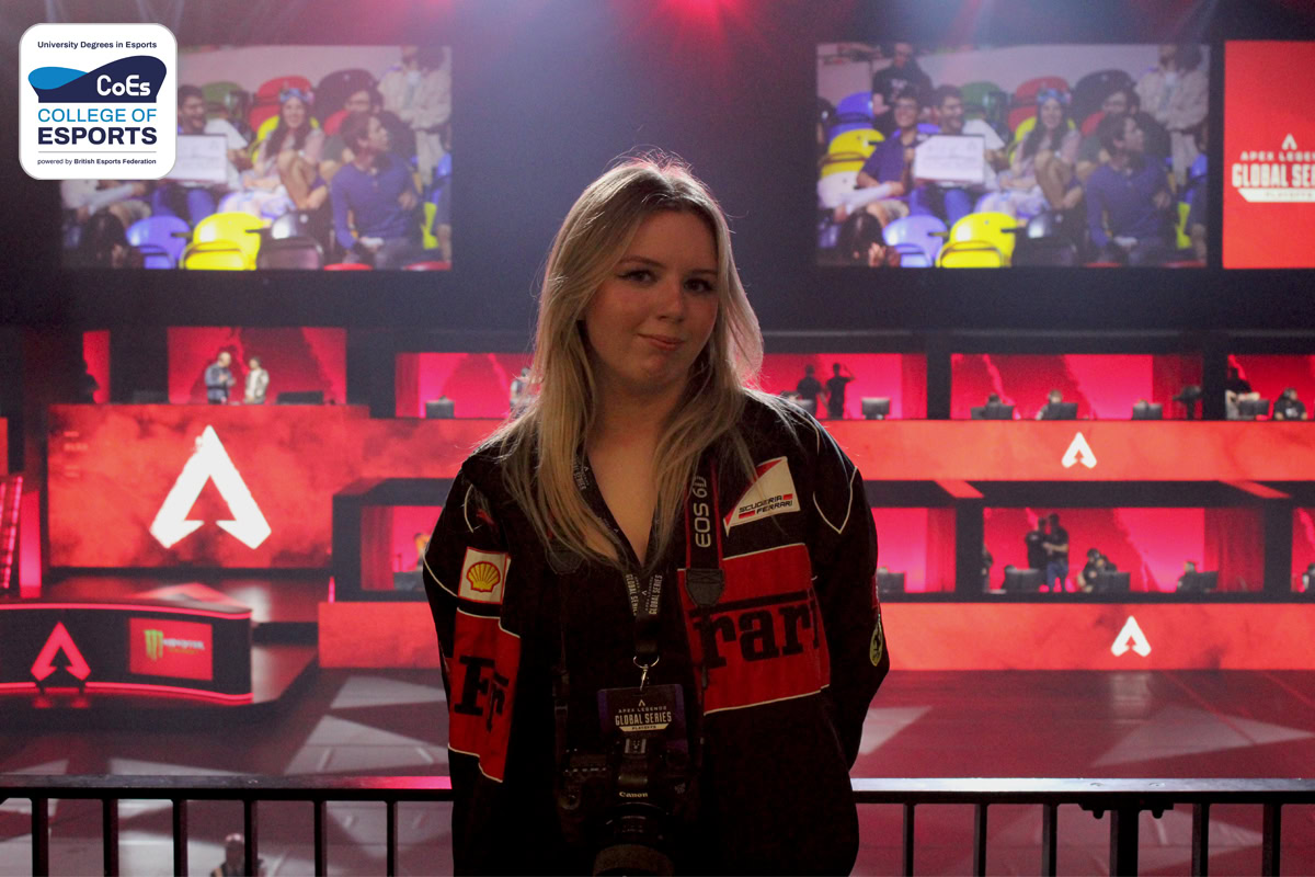 Image shows Molly Sharp with a camera around her neck stood above the stage at the 2023 ALGS Playoffs.