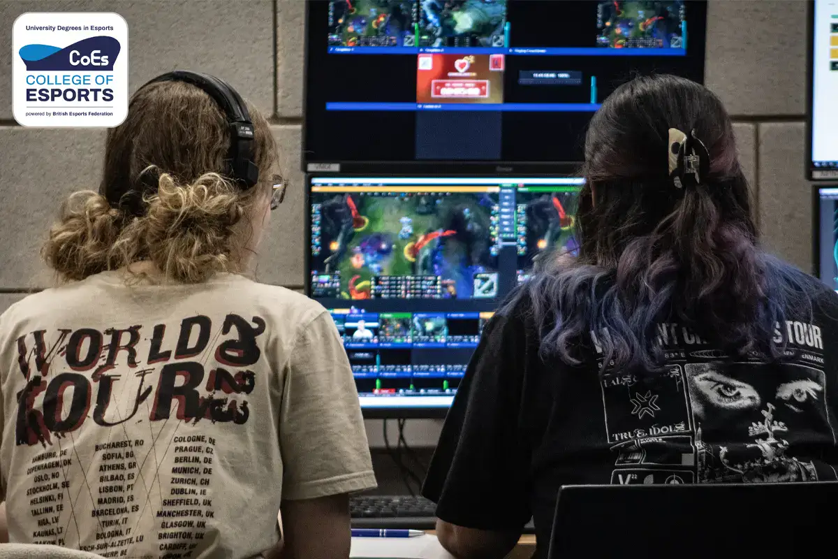 Two female students sat facing screens running a live broadcast with the University Campus of Esports logo in the top left corner.